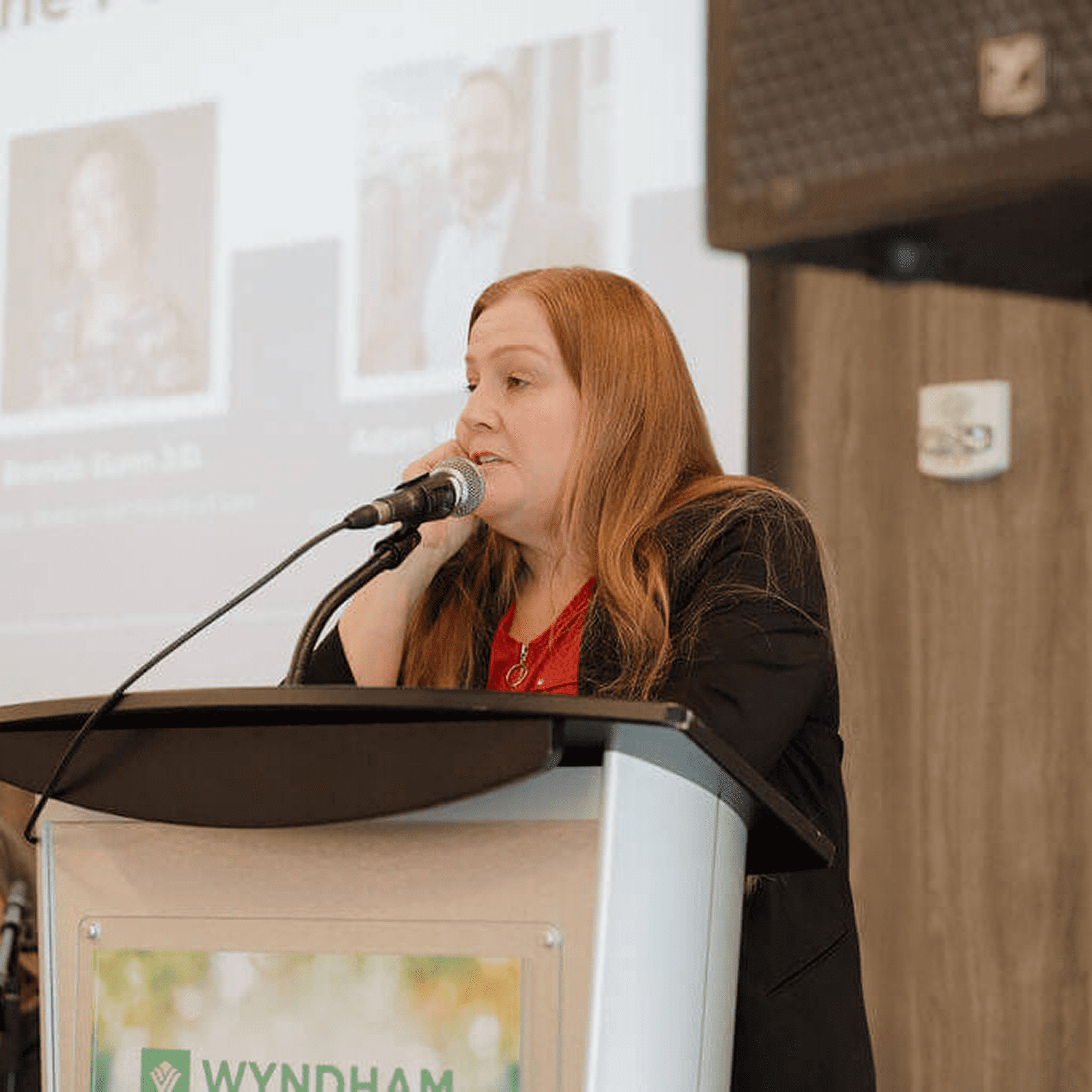Woman speaking at a conference podium