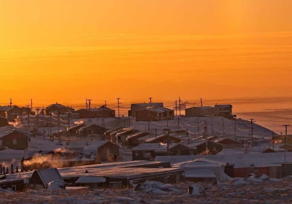 Snowy village at sunset