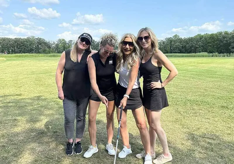 Women posing on a golf course