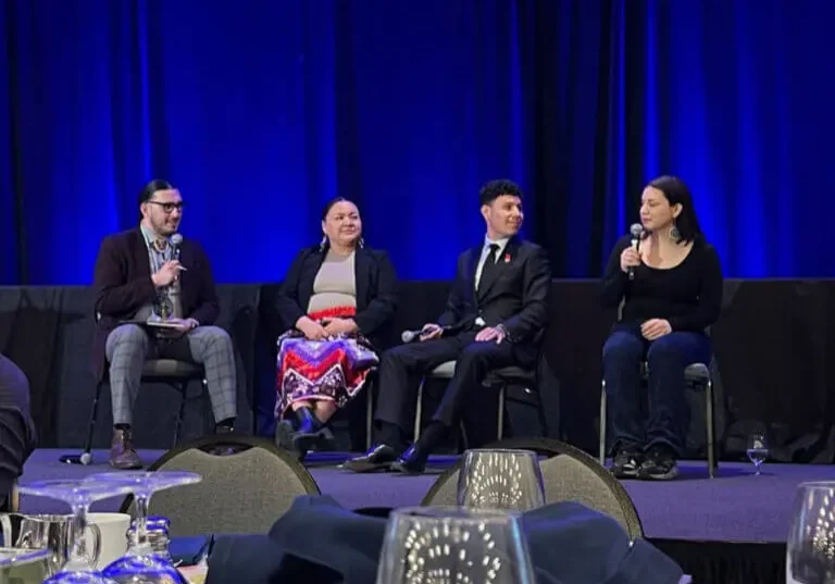 Panel discussion with four speakers on stage