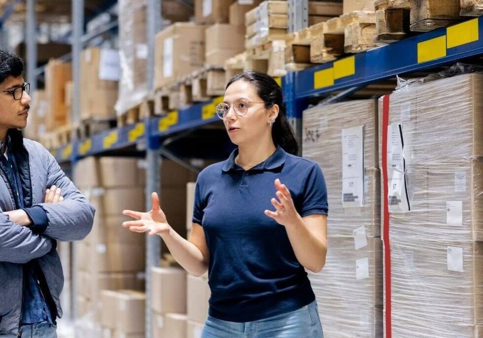 Employees talking in storage facility