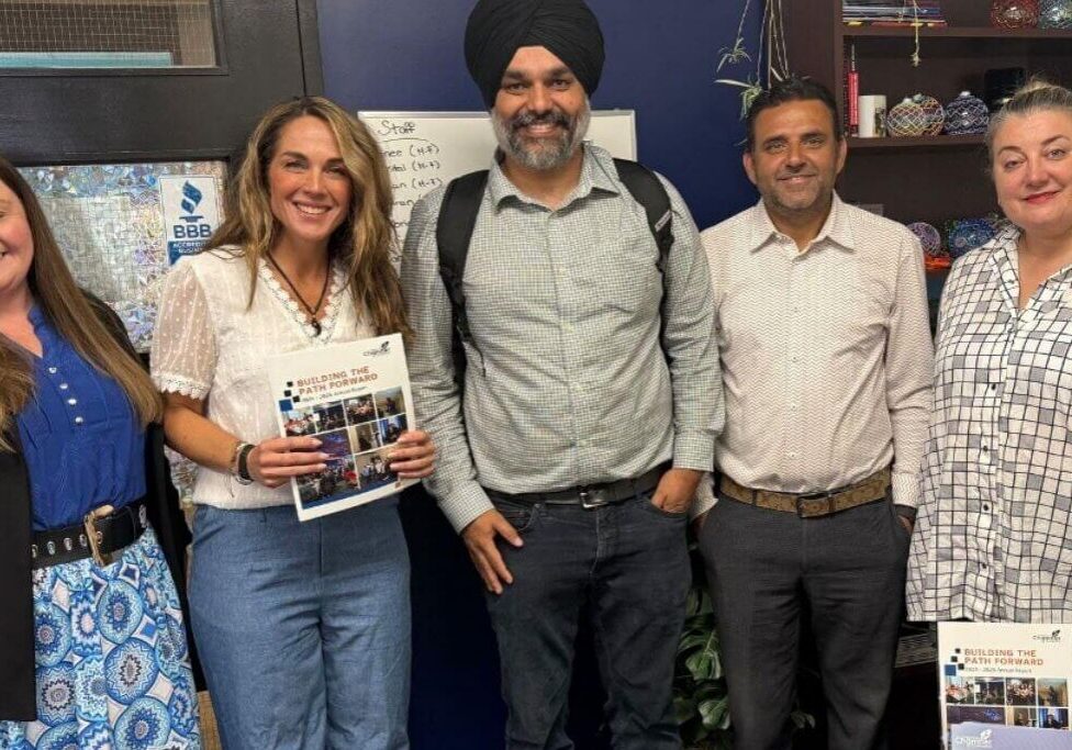 Colleagues posing with brochures