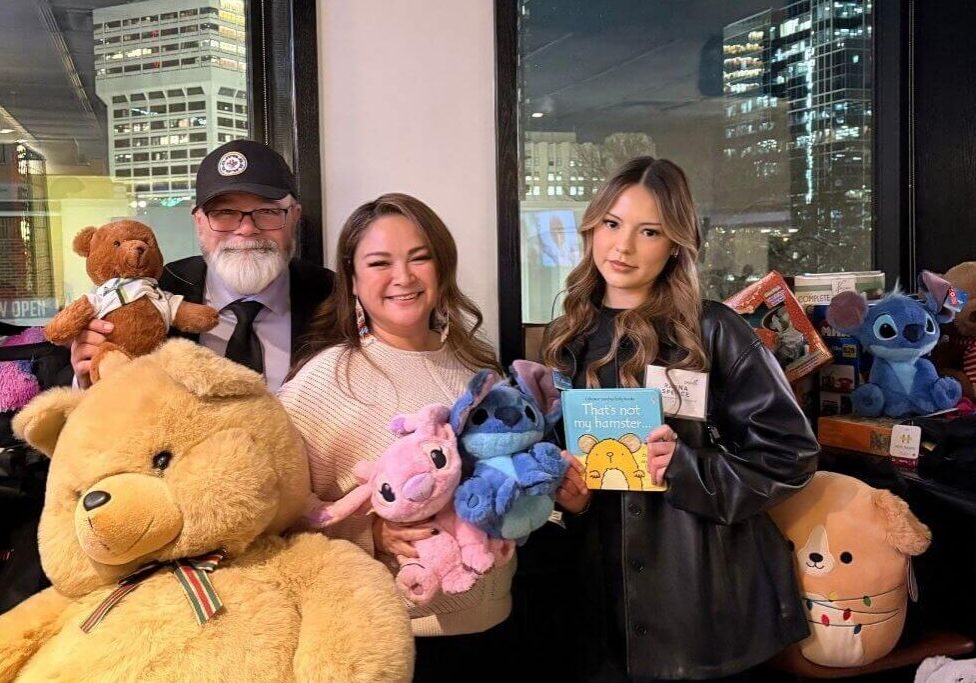 Smiling group holding plush toys