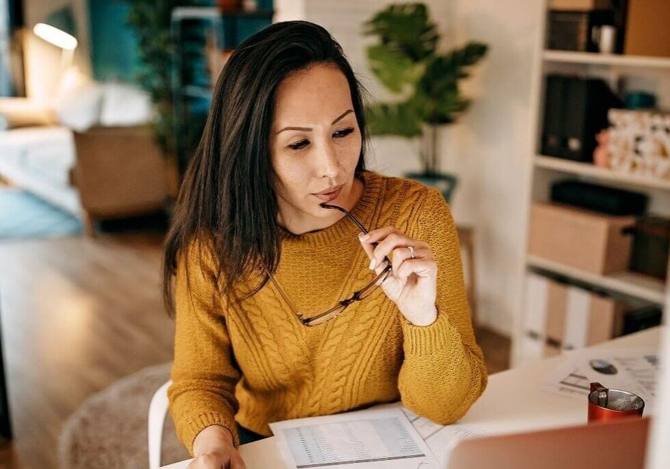Person in yellow sweater using laptop